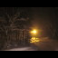 Snowy landscape with streetlights at night